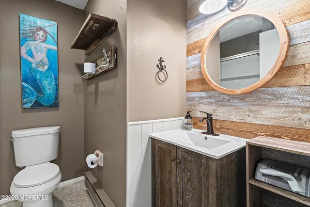 a bathroom with a toilet a sink and mirror