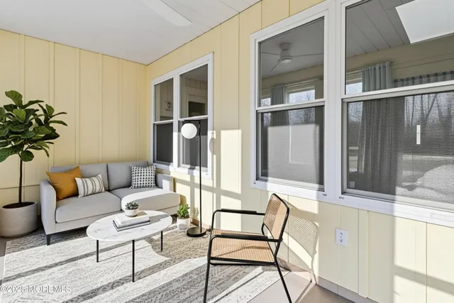 a living room with furniture and a potted plant