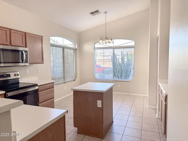 a kitchen with stainless steel appliances a stove sink and microwave