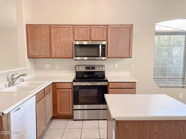 a kitchen with a sink stove and microwave