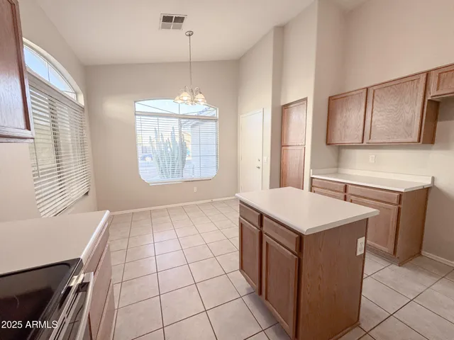 a kitchen with a sink a stove a microwave and cabinets