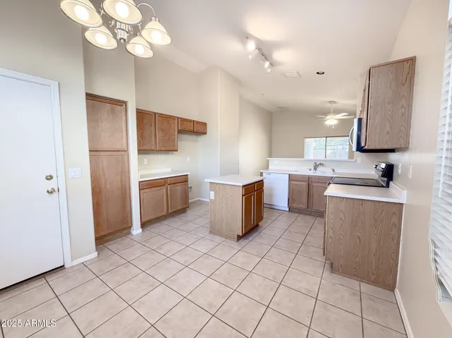 a kitchen with a sink a counter space cabinets and stainless steel appliances