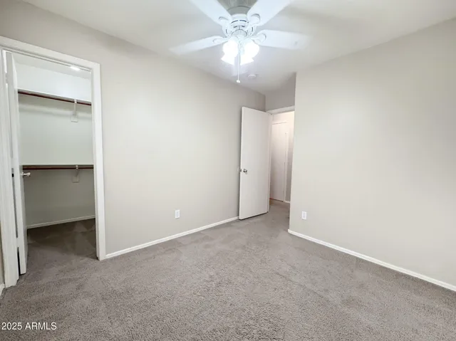 a view of an empty room with a fan