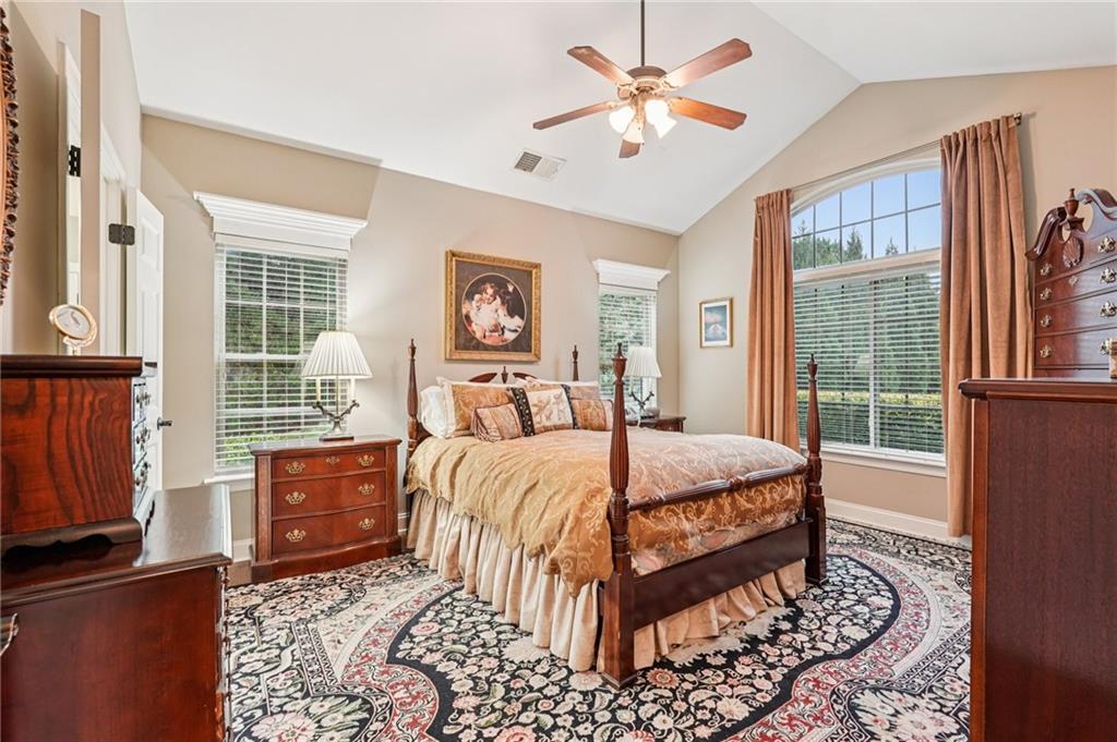 4334 Lanier Ridge Walk, Unit 1403 Cumming, GA 30041 - Photo 12 of 29 a bedroom with a bed dresser and a window