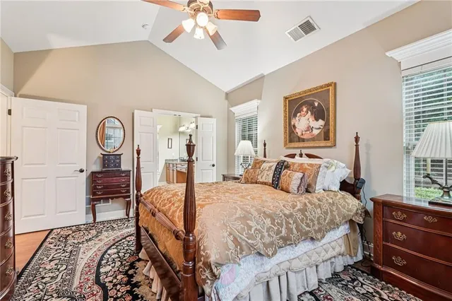 a bedroom with a bed a dresser and chair