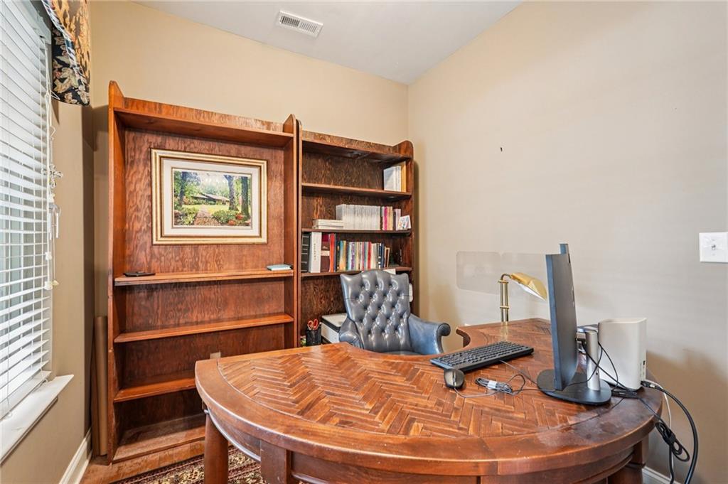 4334 Lanier Ridge Walk, Unit 1403 Cumming, GA 30041 - Photo 15 of 29 a room with furniture and wooden floor