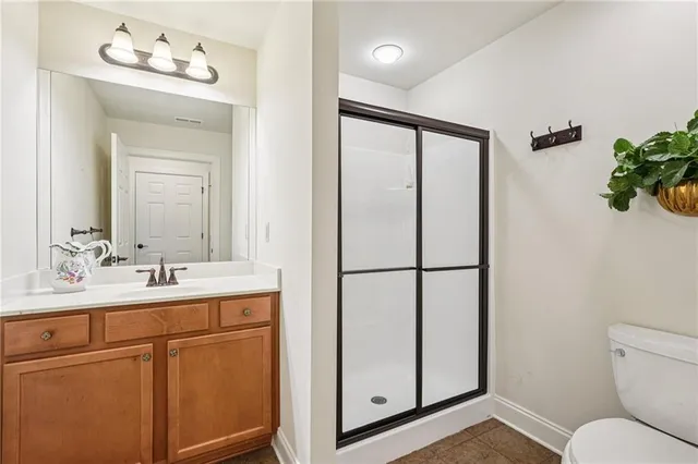 a bathroom with a sink toilet and mirror