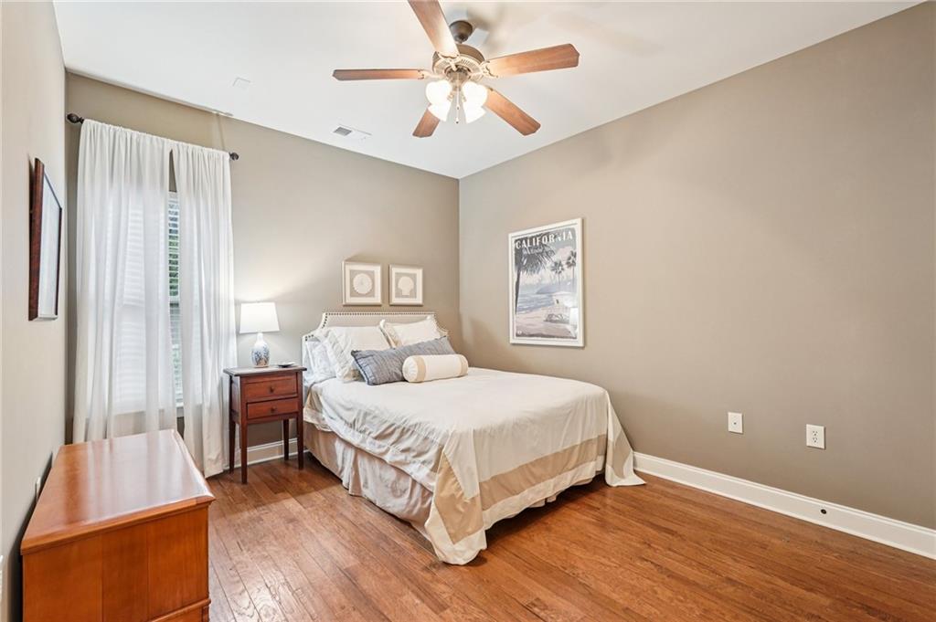 4334 Lanier Ridge Walk, Unit 1403 Cumming, GA 30041 - Photo 20 of 29 a bedroom with a bed and a chandelier