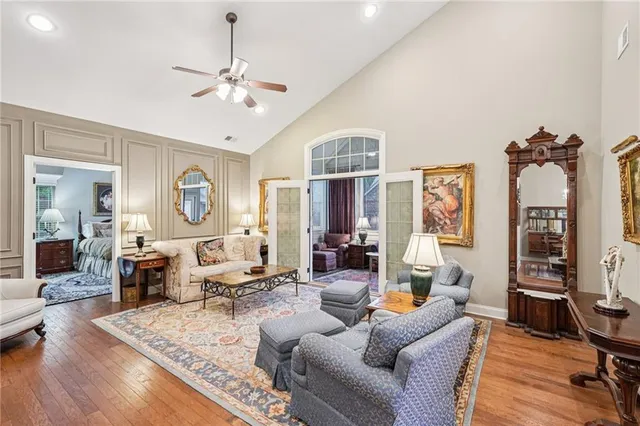 a living room with furniture and a chandelier