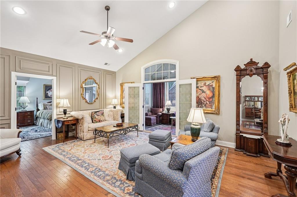 4334 Lanier Ridge Walk, Unit 1403 Cumming, GA 30041 - Photo 2 of 29 a living room with furniture and a chandelier