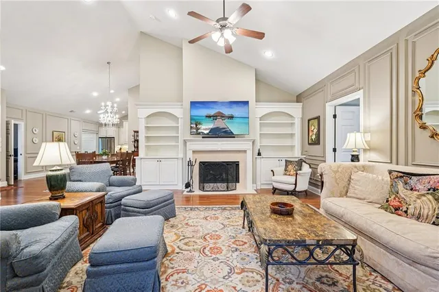 a living room with furniture fireplace and a chandelier