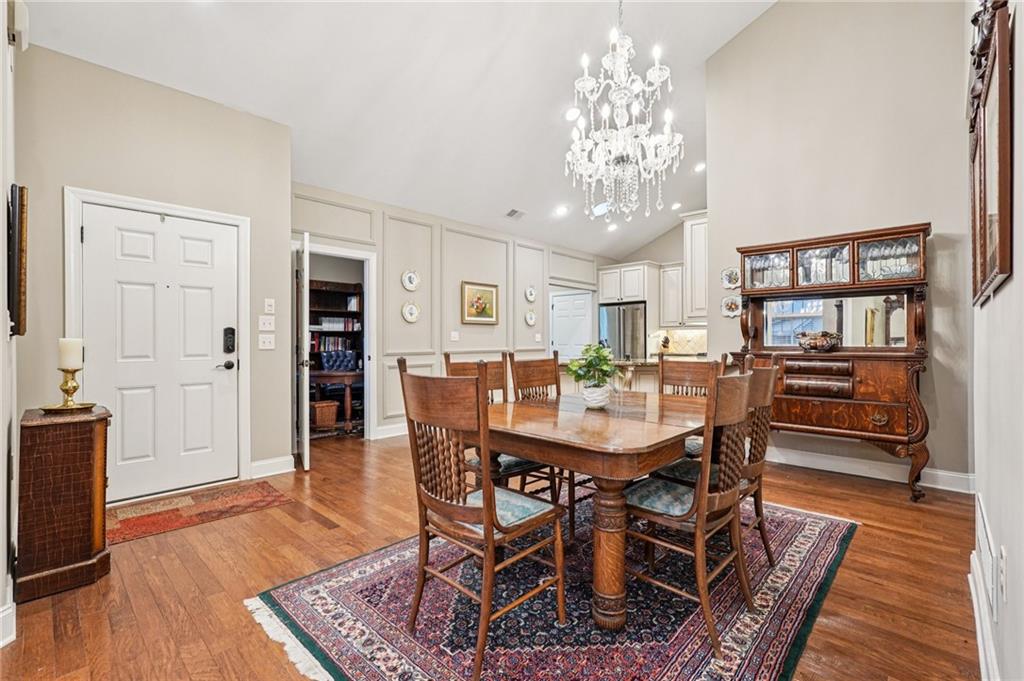 4334 Lanier Ridge Walk, Unit 1403 Cumming, GA 30041 - Photo 6 of 29 a view of a dining room with furniture and wooden floor