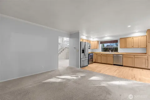 a large white kitchen with a stove a sink and a refrigerator