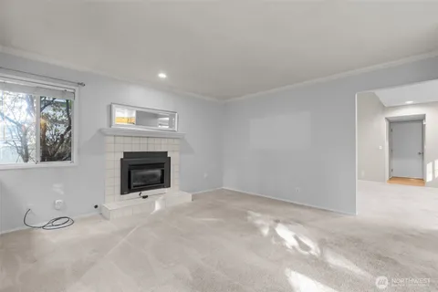 a view of empty room with a fireplace