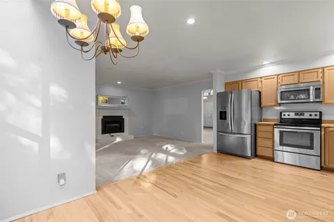 a kitchen with stainless steel appliances granite countertop a refrigerator and a stove top oven