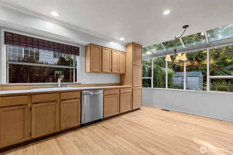a open kitchen with stainless steel appliances granite countertop a sink and cabinets with wooden floor
