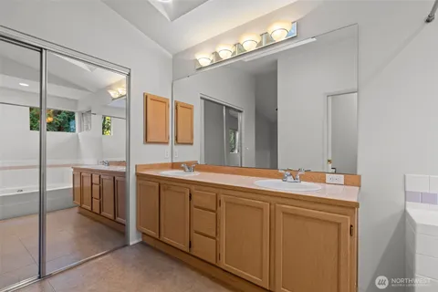 a spacious bathroom with a sink and a mirror