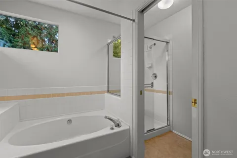 a bathroom with a bathtub and shower