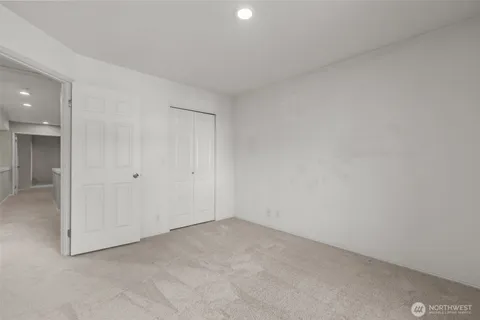 a bathroom with a granite countertop sink a toilet and shower