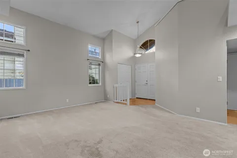 an empty room with windows and closet