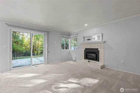 a view of a livingroom with an empty space and a fireplace