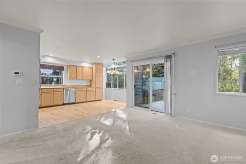 a view of a kitchen with wooden cabinet and windows