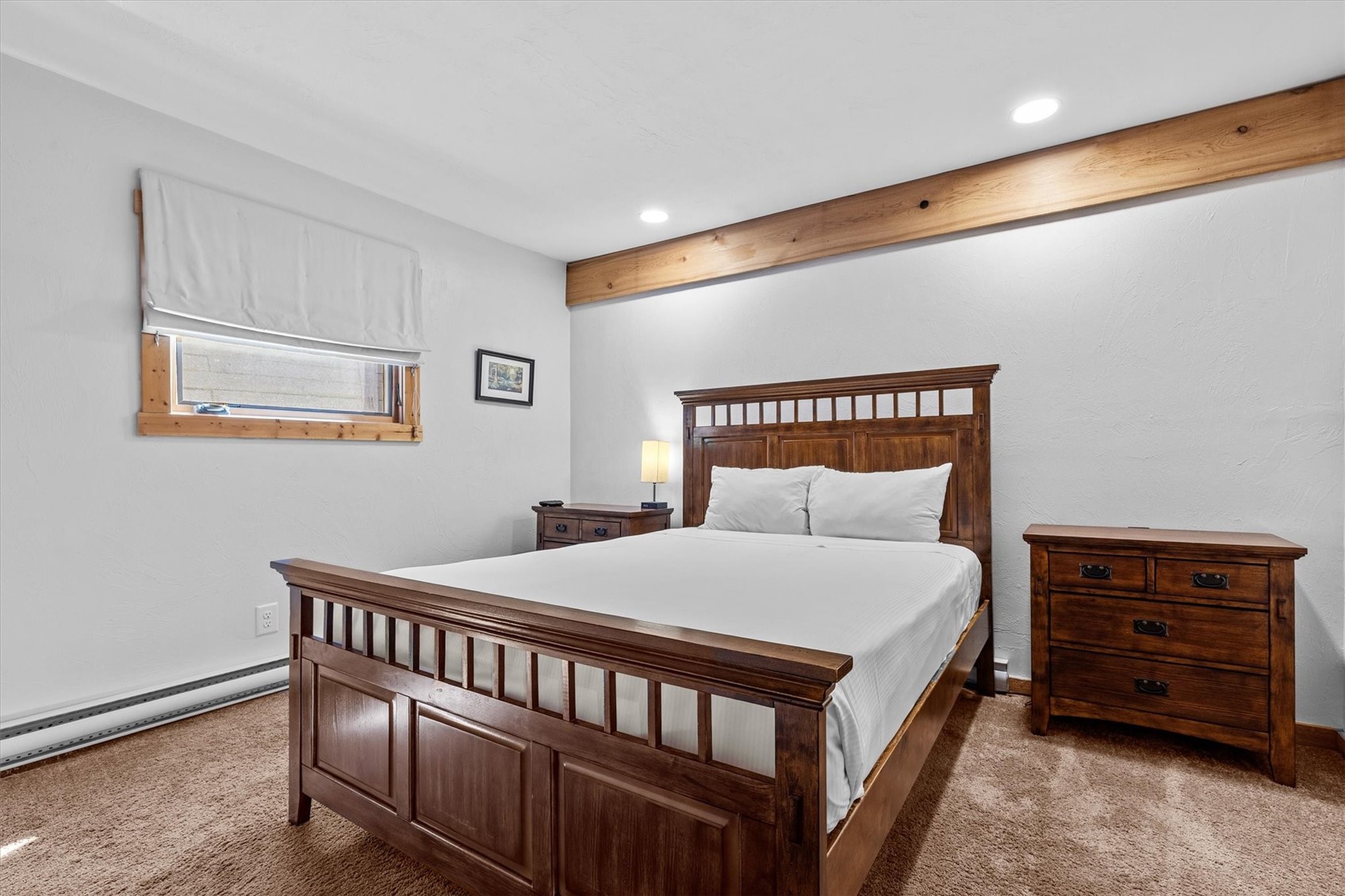 2602 Longthong Road, Unit 107 Steamboat Springs, CO 80487 - Photo 16 of 32 a bedroom with a bed and a dresser