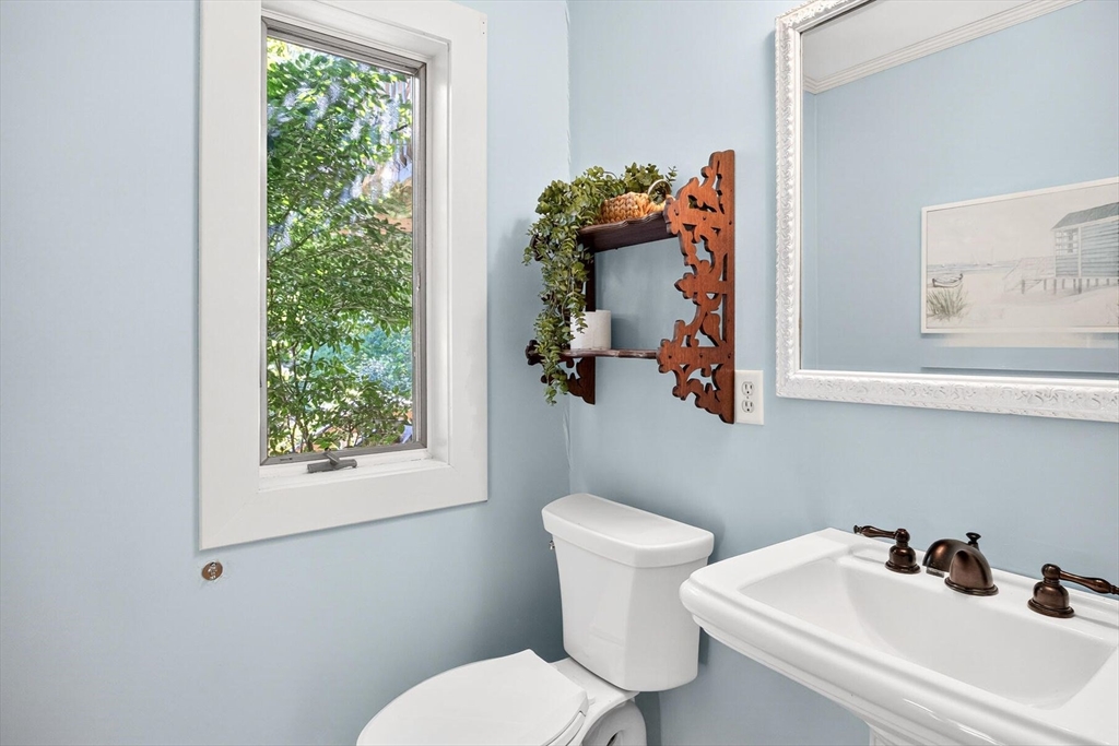 80 Log Cabin Road Eastham, MA 02642 - Photo 12 of 41 a white toilet sitting next to a bathroom sink