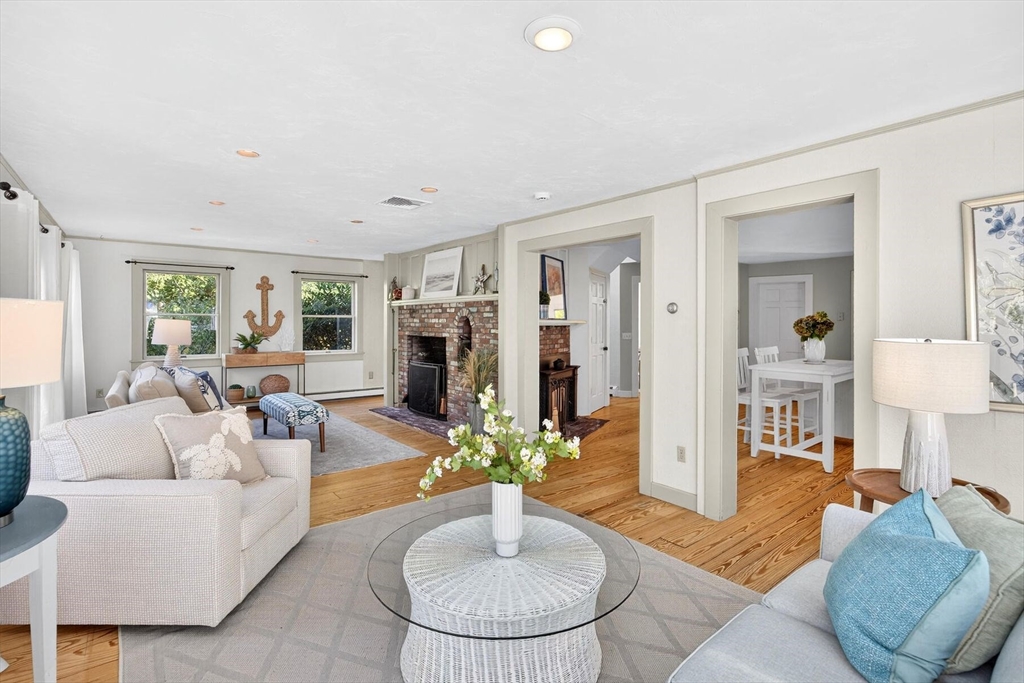 80 Log Cabin Road Eastham, MA 02642 - Photo 26 of 41 a living room with fireplace furniture and a wooden floor