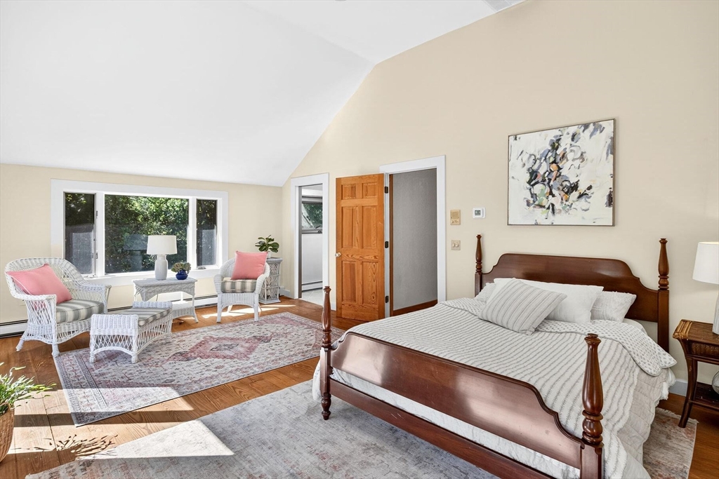 80 Log Cabin Road Eastham, MA 02642 - Photo 32 of 41 a bedroom with a bed a rug and wooden floor