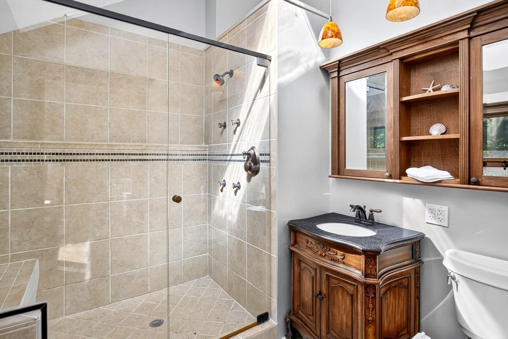 80 Log Cabin Road Eastham, MA 02642 - Photo 33 of 41 a bathroom with a granite countertop sink a toilet and shower
