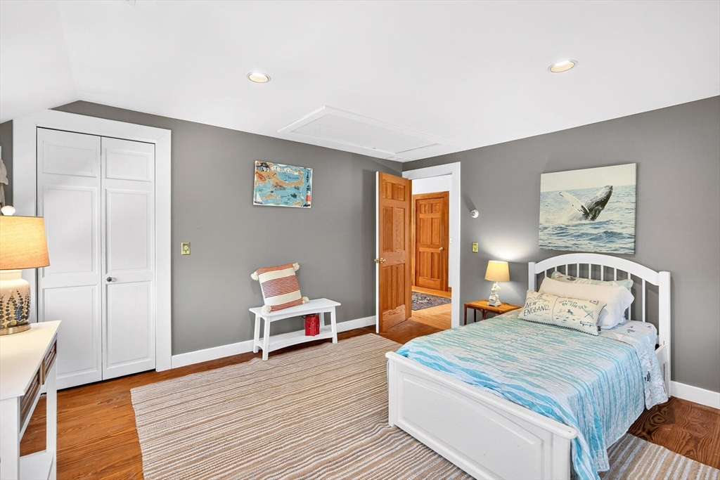 80 Log Cabin Road Eastham, MA 02642 - Photo 34 of 41 a bedroom with a bed and wooden floor