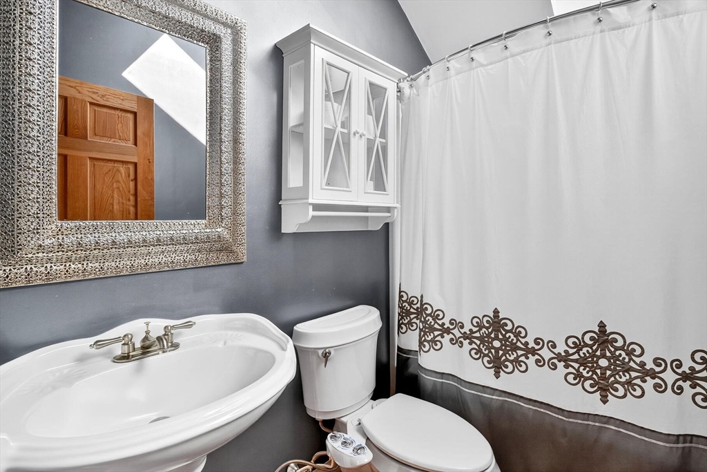 80 Log Cabin Road Eastham, MA 02642 - Photo 35 of 41 a bathroom with a sink and mirror with toilet
