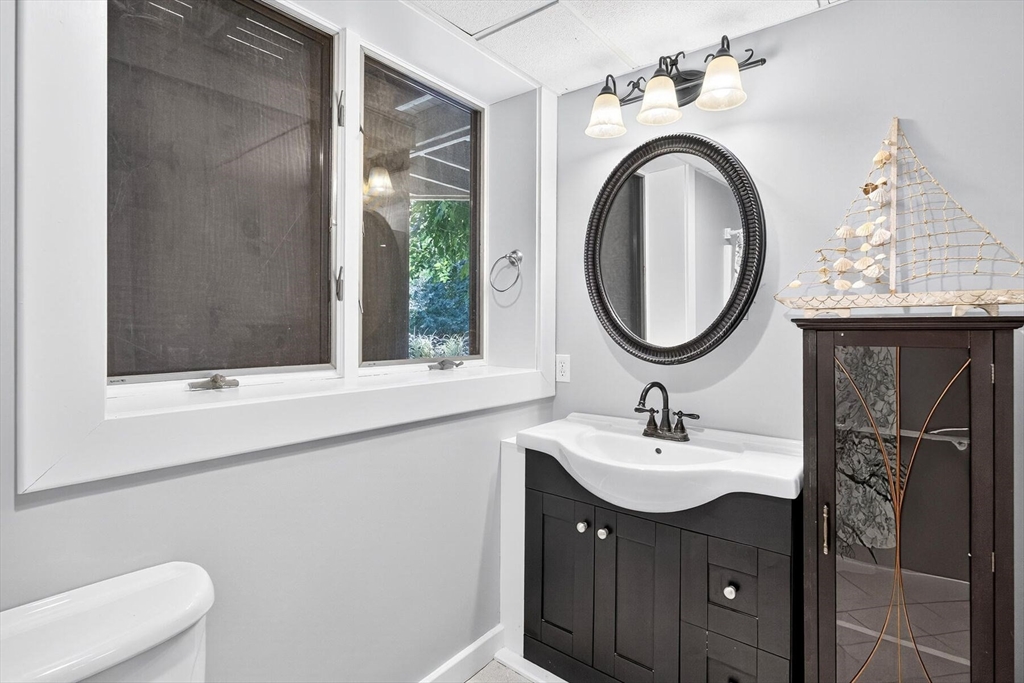 80 Log Cabin Road Eastham, MA 02642 - Photo 39 of 41 a bathroom with a sink and a mirror