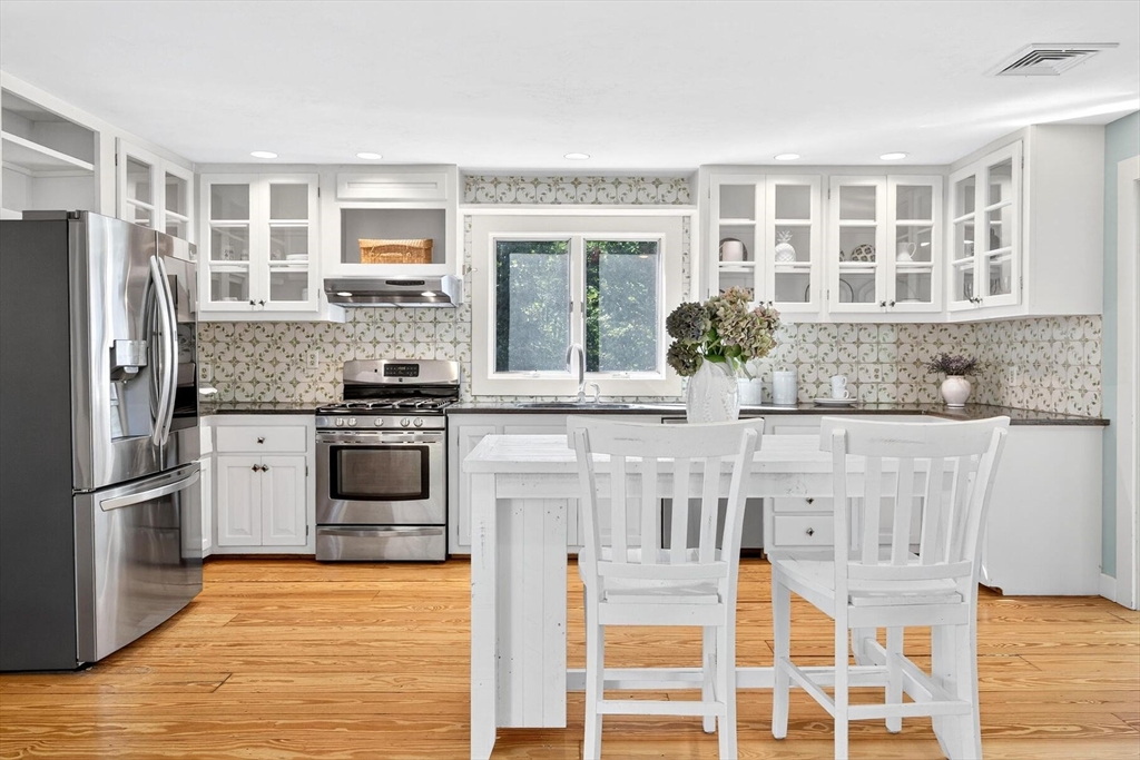 80 Log Cabin Road Eastham, MA 02642 - Photo 7 of 41 a kitchen with stainless steel appliances granite countertop a stove and a refrigerator