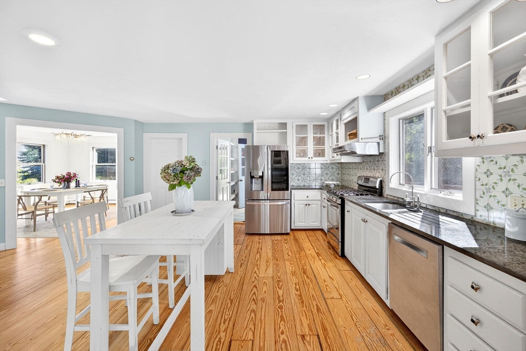 80 Log Cabin Road Eastham, MA 02642 - Photo 8 of 41 a large kitchen with stainless steel appliances microwave a stove and white cabinets