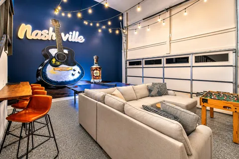 a living room with furniture and a chandelier