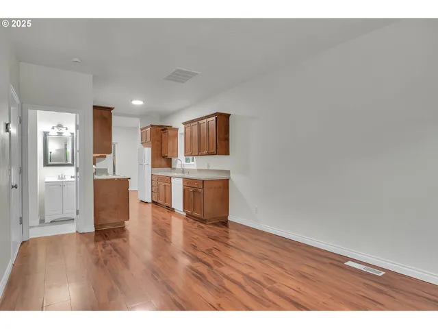 a view of kitchen with cabinets and wooden floor