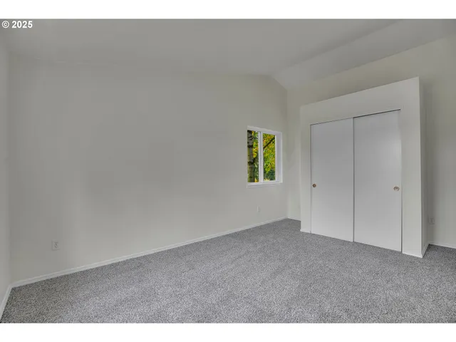 a view of an empty room and a window