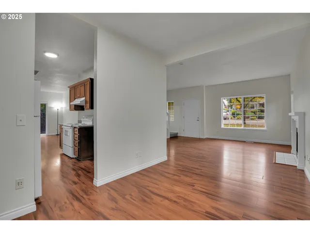 a view interior of a house wooden floor an entryway and a living room