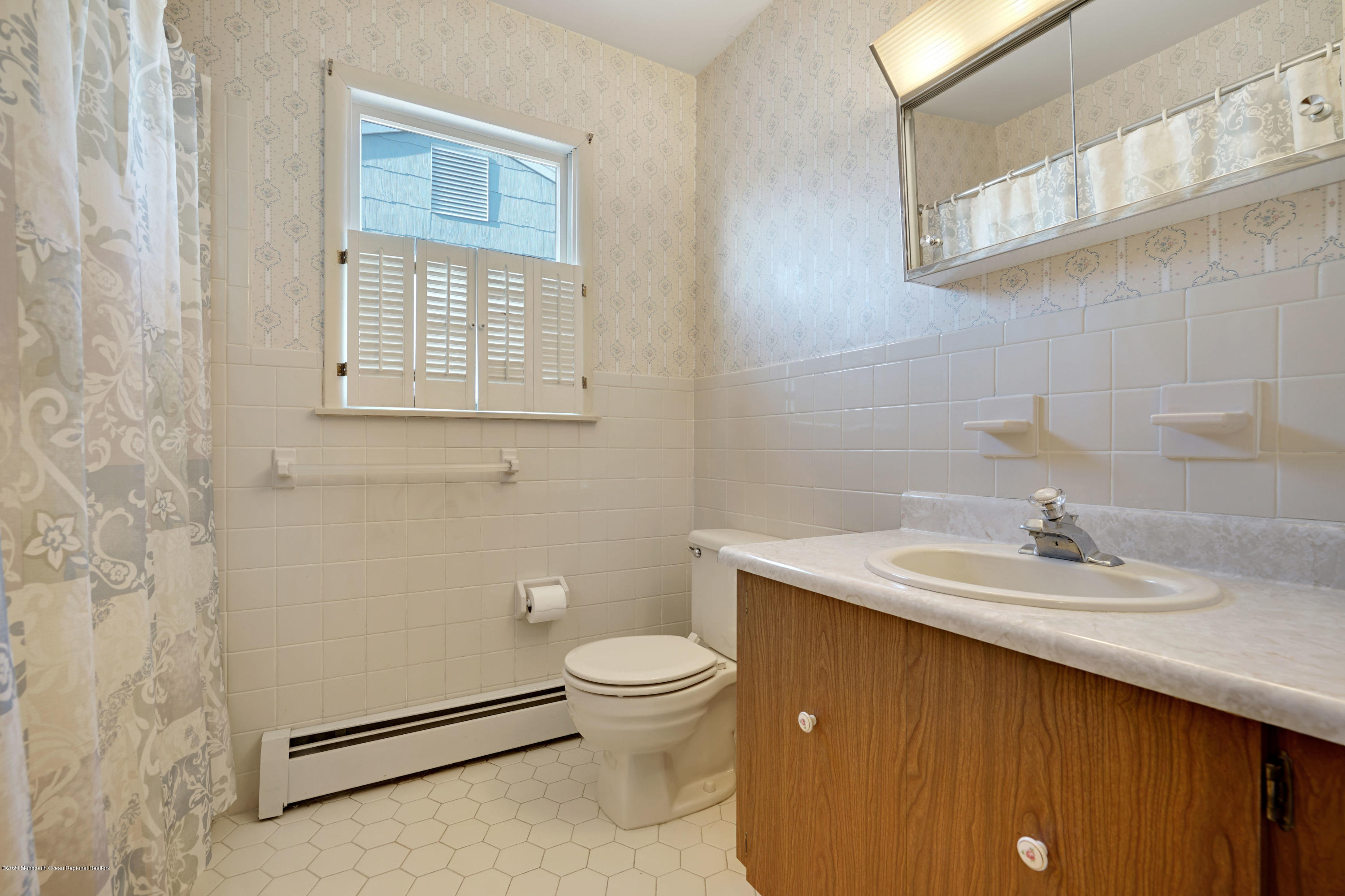 18 Mapleton Road Toms River, NJ 08757 - Photo 9 of 18 a bathroom with a sink a toilet and a mirror