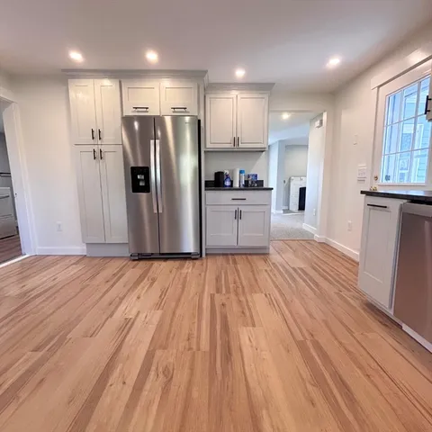 a kitchen with stainless steel appliances a refrigerator sink and microwave
