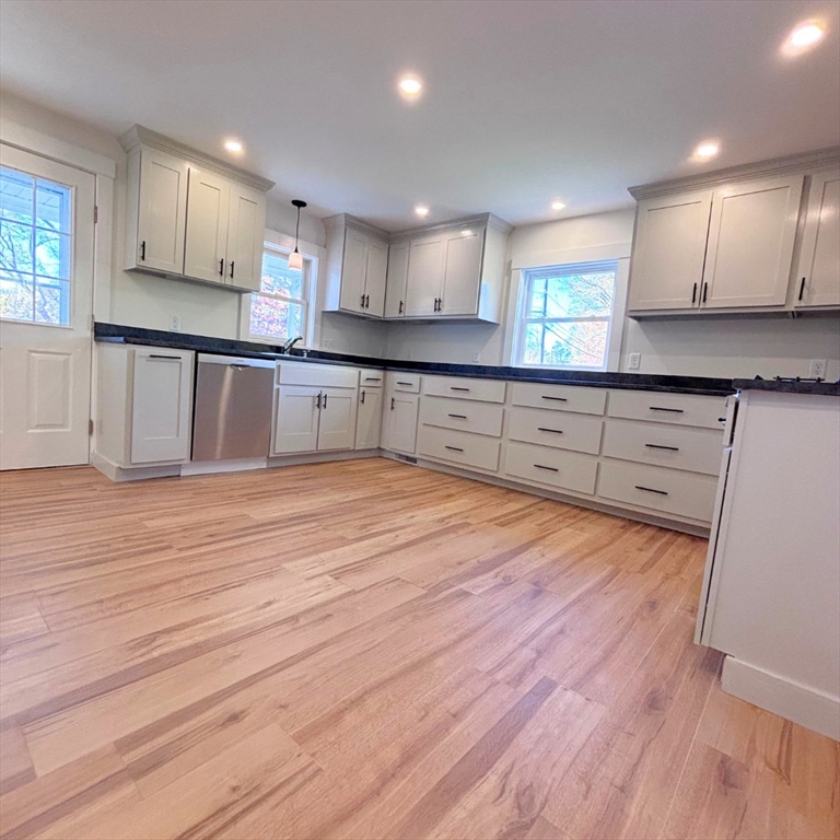 301 Central Street Hudson, MA 01749 - Photo 6 of 33 a large kitchen with wooden floors stainless steel appliances and cabinets
