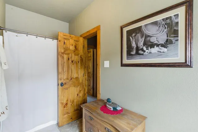 a bathroom with a shower and a sink