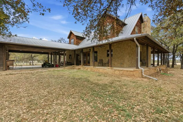 a view of a backyard with a bench and wooden fence