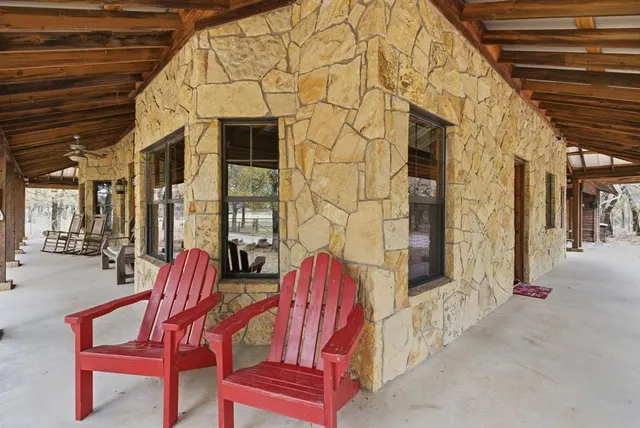 a view of a patio with a table and chairs