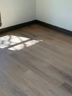 a view of a room with wooden floor and window