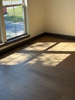 a view of room with wooden floor and a window