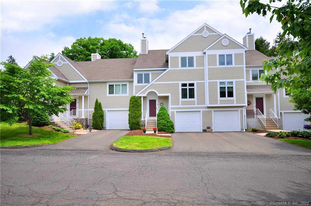22 Madison Lane, Unit 22 Avon, CT 06001 - Photo 1 of 1 a front view of a house with a yard and garage