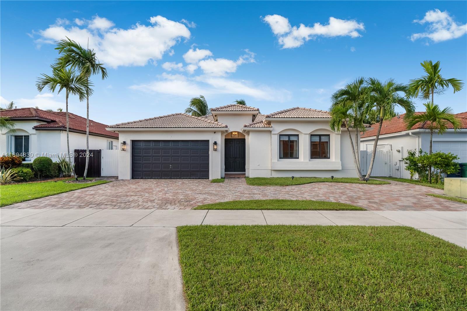 16429 Southwest 54th Terrace Miami, FL 33185 - Photo 1 of 28 a front view of a house with a yard and garage